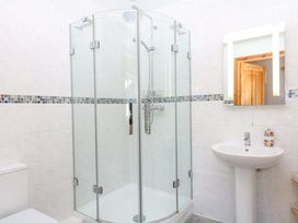 A bathroom with a shower and sink at The Milk Shed in Plymtree