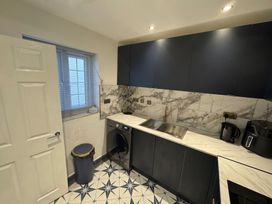 A kitchen with cabinets, sink, and appliances at the property