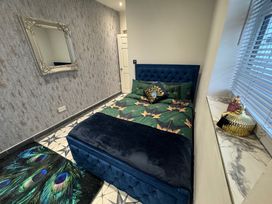 A bedroom with a bed and decorative pillows at The Old Barn in Manchester