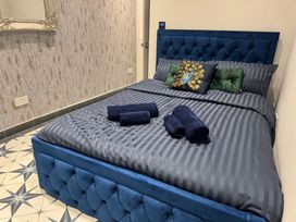 A bedroom with a bed and decorative pillows at a property in an unspecified location