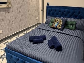 A bedroom with a blue bed and decorative pillows at a property in location
