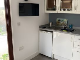 A kitchen with a sink and refrigerator at The Nook in 
