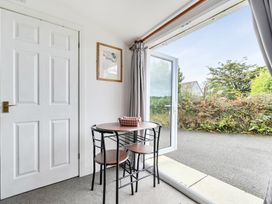 A dining area with a table and chairs at The Nook in Praa Sands