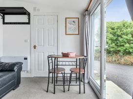A dining room with a table and chairs at The Nook in Praa Sands