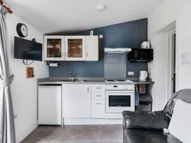 A kitchen with appliances and furniture at The Nook in Praa Sands
