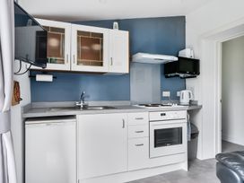 A kitchen with appliances and cabinets at The Nook in Praa Sands