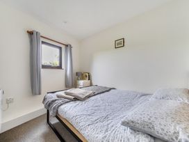 A bedroom with a bed and window at The Nook in Praa Sands