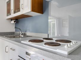 A kitchen with a stove and sink at The Nook in Praa Sands