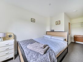 A bedroom with a bed and dresser at The Nook in Praa Sands