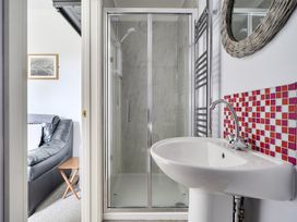 A bathroom with a shower and sink at The Nook in Praa Sands