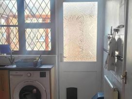 A utility room with a washing machine and sink at 