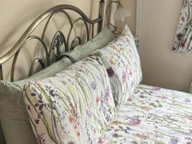 A bed with patterned pillows and a lamp at a property