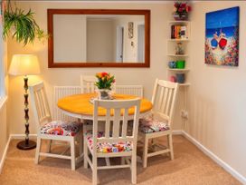 A dining area with a table and chairs at Quackers Heacham