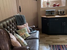 A kitchen with a sofa and countertop appliances at High Dyke Cottage