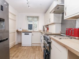 A kitchen with appliances and countertop at Orchard Cottage in Dawlish