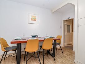 A dining room with a table and chairs at Orchard Cottage in Dawlish