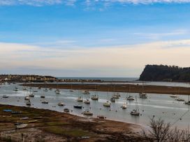 A water view with boats and land at Orchard Cottage in Dawlish