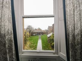 A view from a window showing a garden and buildings at ASH HOUSE