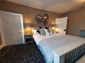 A bedroom with a bed and bedside table at ASH HOUSE in Wincanton