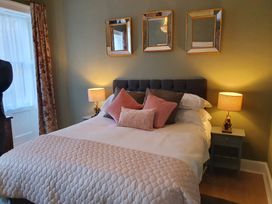 A bedroom with a bed and lamp at ASH HOUSE in Wincanton