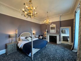 A bedroom with a bed and fireplace at ASH HOUSE Wincanton