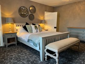 A bedroom with a bed and nightstand at ASH HOUSE in Wincanton