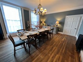 A dining room with a large table and chairs at ASH HOUSE in Wincanton