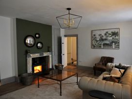 A living room with a fireplace and coffee table at ASH HOUSE in Wincanton