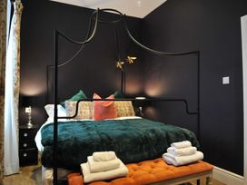 A bedroom with a bed and bedside table at ASH HOUSE in Wincanton