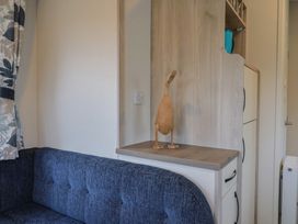 A living room with a sofa and wooden ornament at caravan NEW in Uplyme