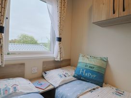 A bedroom with two beds and a window at caravan NEW in Uplyme