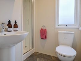 A bathroom with a sink, shower, and toilet at caravan NEW in Uplyme