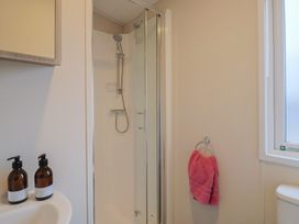A bathroom with a shower and sink at caravan NEW in Uplyme