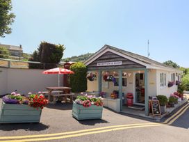 An outdoor reception and shop area with flowers at caravan NEW Uplyme
