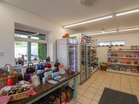 A shop interior with shelves and snacks at caravan NEW Uplyme