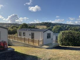 A caravan with decking in a hilly area at caravan NEW Uplyme