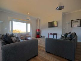 A living room with sofas and a television at Chynoweth in Crantock