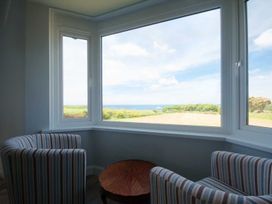 A living room with a view of the sea at Chynoweth in Crantock