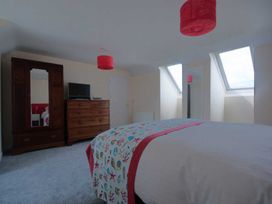 A bedroom with a bed and television at Chynoweth in Crantock