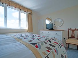 A bedroom with a bed and television at Chynoweth in Crantock