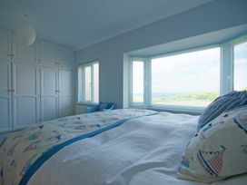 A bedroom with a bed and window at Chynoweth in Crantock