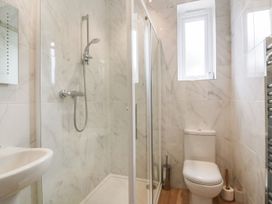 A bathroom with a shower, toilet, and sink at Chynoweth in Crantock