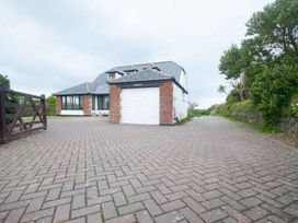 A house with a garage and driveway at Chynoweth in Crantock