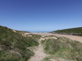 A beach with sand and water at Chynoweth Crantock