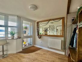 A hallway with a mirror and coat rack at 