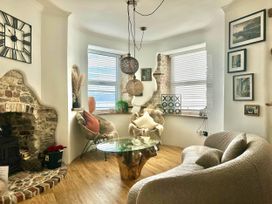 A living room with a glass table and decorative elements at The Old Barn in Manchester