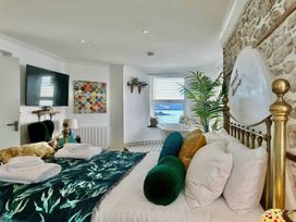 A bedroom with a bed and a view of the sea at The Old Barn in Manchester