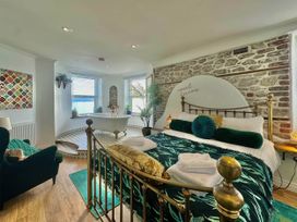 A bedroom with a bed and a bathtub at The Old Barn in Manchester