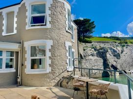 An outdoor area with seating and a view at Seafront Cottage
