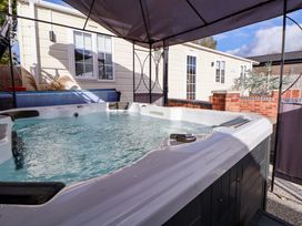 A hot tub in an outdoor setting at Lodge in Talacre